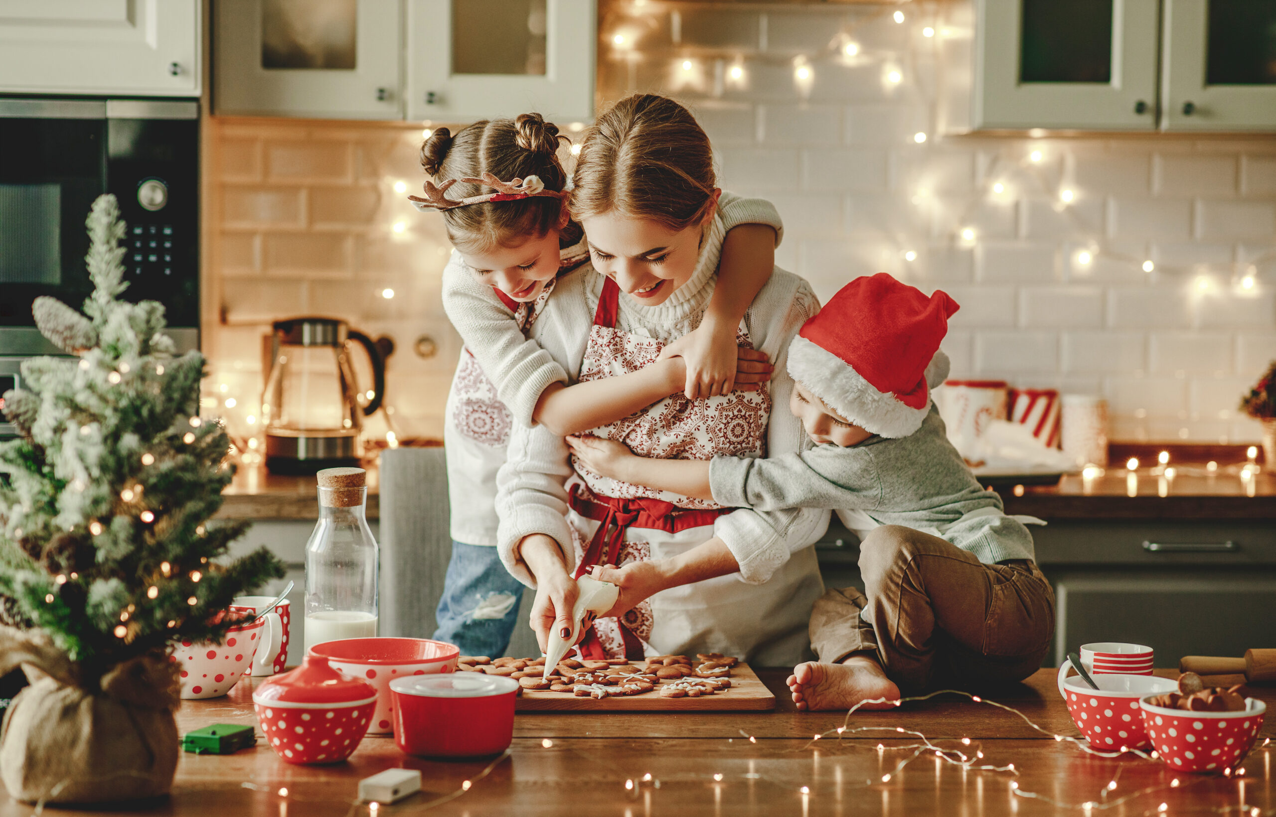 happy family mother and children bake christmas cookies enjoying warmth from a new furnace